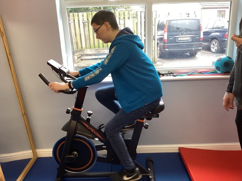 A learner at Three Bridges Special Educational Needs school in Truro, using the gym for his daily exercise.